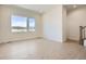Spacious, light-filled living room with hardwood floors and large windows with views at 647 Skyhook St, Erie, CO 80516
