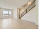 Bright living room features light hardwood floors and large windows for ample natural light at 647 Skyhook St, Erie, CO 80516
