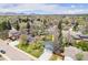 Aerial view showcasing a well-maintained home with solar panels, lush greenery, and a peaceful neighborhood setting at 12175 W 68Th Pl, Arvada, CO 80004