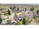 Aerial shot featuring the property with a deck, mature trees, and a well-kept lawn in a serene neighborhood at 12175 W 68Th Pl, Arvada, CO 80004
