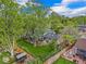 Aerial view of a landscaped backyard with a patio, lawn, fence, and a two-story home at 12175 W 68Th Pl, Arvada, CO 80004