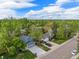 Charming home featuring mature trees, solar panels, and a well-maintained lawn, set against a bright blue sky at 12175 W 68Th Pl, Arvada, CO 80004