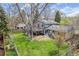 Aerial shot showcasing the home's backyard with a deck, patio, lush lawn, and privacy fencing at 12175 W 68Th Pl, Arvada, CO 80004