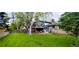 Large backyard featuring lush lawn, mature trees, and patio beneath an upper deck at 12175 W 68Th Pl, Arvada, CO 80004