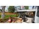 Landscaped backyard with a patio, fire pit, benches, and stairs to upper deck at 12175 W 68Th Pl, Arvada, CO 80004