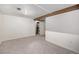 Finished basement with carpet flooring, neutral walls, and exposed beam at 12175 W 68Th Pl, Arvada, CO 80004