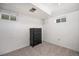 Basement with carpet flooring featuring a dresser and two windows for natural light at 12175 W 68Th Pl, Arvada, CO 80004