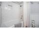 Modern bathroom with a white subway tile shower and updated fixtures at 12175 W 68Th Pl, Arvada, CO 80004