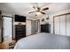 Primary bedroom featuring wood floors, a ceiling fan, closet and ensuite bath at 12175 W 68Th Pl, Arvada, CO 80004