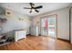 Bright bedroom with cat furniture, hardwood floors, and a sliding door to outside at 12175 W 68Th Pl, Arvada, CO 80004