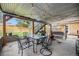Backyard covered patio featuring string lights, outdoor dining, and lounging area at 12175 W 68Th Pl, Arvada, CO 80004