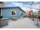 Large deck perfect for outdoor gatherings with seating, an umbrella, and a convenient storage box at 12175 W 68Th Pl, Arvada, CO 80004