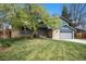 Charming two-story home featuring a brick facade, well-manicured lawn, and a two-car garage at 12175 W 68Th Pl, Arvada, CO 80004