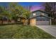 Charming two-story home featuring a brick facade, well-manicured lawn, and a two-car garage at 12175 W 68Th Pl, Arvada, CO 80004