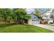Charming two-story home with a brick facade, blue siding, and a well-manicured lawn at 12175 W 68Th Pl, Arvada, CO 80004