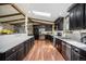 Stunning kitchen featuring dark wood cabinetry, stainless steel appliances, and a skylight that adds natural light at 12175 W 68Th Pl, Arvada, CO 80004