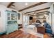 Cozy living room with wood-burning fireplace, exposed beams, and lots of natural light at 12175 W 68Th Pl, Arvada, CO 80004