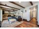 Living room with wood-beamed ceilings, brick fireplace, and hardwood flooring at 12175 W 68Th Pl, Arvada, CO 80004