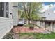 The backyard has a tiled patio with fire pit, a small deck, and a fence for privacy at 17943 E Bates Ave, Aurora, CO 80013