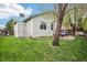 View of the backyard featuring green grass and a patio area, ideal for outdoor enjoyment at 17943 E Bates Ave, Aurora, CO 80013
