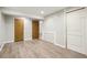 A finished basement with wood style vinyl flooring and natural color doors at 17943 E Bates Ave, Aurora, CO 80013