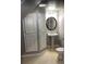 This half bath features a pedestal sink and storage cabinets at 17943 E Bates Ave, Aurora, CO 80013