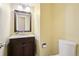 Bathroom with a dark wood vanity, granite countertop, and a decorative mirror at 17943 E Bates Ave, Aurora, CO 80013
