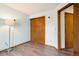 A bright bedroom with a sliding closet and wood-style vinyl flooring at 17943 E Bates Ave, Aurora, CO 80013