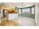 Open-concept kitchen with stainless steel appliances, wood cabinets, and breakfast bar at 17943 E Bates Ave, Aurora, CO 80013