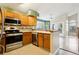 Bright kitchen featuring stainless steel appliances, light oak cabinets, and tile backsplash detail at 17943 E Bates Ave, Aurora, CO 80013