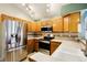 Modern kitchen featuring stainless steel appliances, light oak cabinets and countertops with tiled backsplash at 17943 E Bates Ave, Aurora, CO 80013