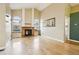 Sunlit living room with a wooden fireplace, hardwood floors, and neutral-colored walls at 17943 E Bates Ave, Aurora, CO 80013