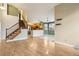 Open floor plan showcasing hardwood floors, kitchen access, and stairs to the upper level at 17943 E Bates Ave, Aurora, CO 80013