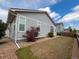 Exterior side view of a home with landscaped backyard and blue sky at 1688 Aquamarine Dr, Brighton, CO 80603