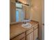 Bathroom featuring vanity with a sink and mirror, accented by the view into an adjacent room at 1688 Aquamarine Dr, Brighton, CO 80603