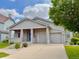 Inviting single-story home featuring a well-manicured lawn, covered porch, and a two-car garage at 1688 Aquamarine Dr, Brighton, CO 80603