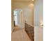 Bright upper-level hallway with carpet flooring and an arched entryway, leading to various rooms at 1688 Aquamarine Dr, Brighton, CO 80603
