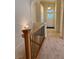Bright hallway showcases access to the front door and stairway with modern metal railings at 1688 Aquamarine Dr, Brighton, CO 80603