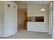Bright living room features neutral colors and open floor plan flowing into the kitchen area at 1688 Aquamarine Dr, Brighton, CO 80603