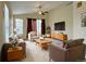 Inviting living room featuring cozy seating, a ceiling fan, and a flat screen TV at 1688 Aquamarine Dr, Brighton, CO 80603