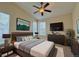 The main bedroom offers a ceiling fan, large windows, and is decorated with art at 1688 Aquamarine Dr, Brighton, CO 80603
