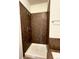 Shower features bronze tile surround and neutral colors at 1688 Aquamarine Dr, Brighton, CO 80603
