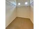 Spacious walk-in closet with shelving, carpeted floor, and small inset windows at 1688 Aquamarine Dr, Brighton, CO 80603