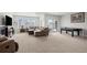 Finished basement with recreation area, featuring a sectional sofa and game table at 12664 Ulster St, Thornton, CO 80602