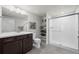 Modern bathroom with double vanity and a large shower at 12664 Ulster St, Thornton, CO 80602