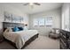 Bright bedroom with king-size bed and an accent chair at 12664 Ulster St, Thornton, CO 80602