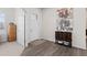 Bright and spacious entryway with wood-look floors and art at 12664 Ulster St, Thornton, CO 80602