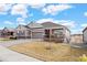 House exterior featuring a two-car garage and well-maintained lawn at 12664 Ulster St, Thornton, CO 80602