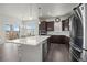 Open concept kitchen features stainless steel appliances and an island at 12664 Ulster St, Thornton, CO 80602