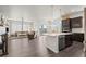 Modern kitchen with dark cabinets, island, and stainless steel appliances at 12664 Ulster St, Thornton, CO 80602